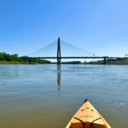 Kayak on river with bridge